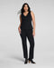 Woman wearing a black sleeveless top and black pants on a white background