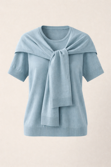 Light blue sweater with a scarf draped over the shoulders on a beige background