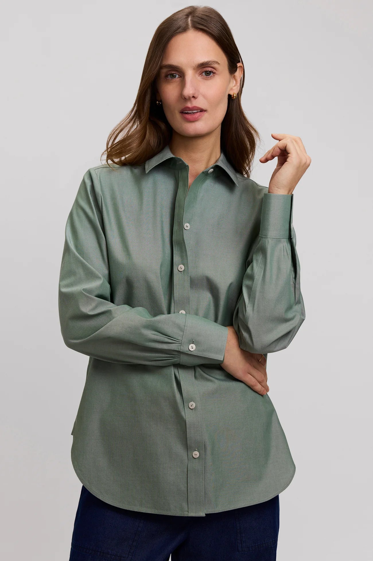 Woman wearing a green shirt against a plain background