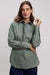 Woman wearing a green shirt against a plain background