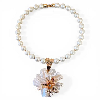 Pearl necklace with a floral pendant on a white background