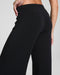 Black pants worn by a person on a gray background