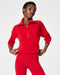 Person wearing a red fleece outfit on a white background