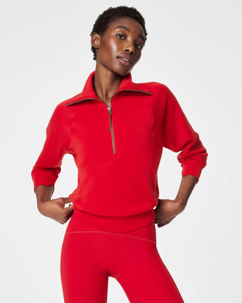 Person wearing a red fleece outfit on a white background