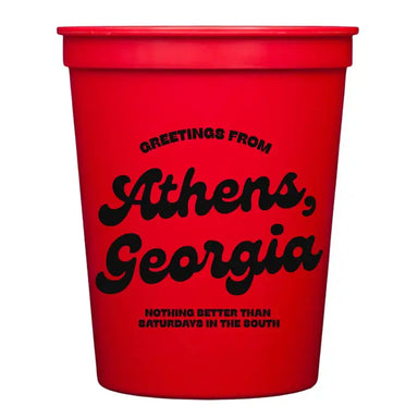 Red cup with black text 'Greetings from Athens, Georgia. Nothing better than Saturdays in the south.'