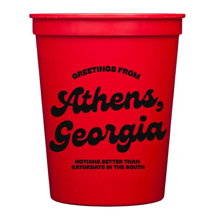 Red cup with black text 'Greetings from Athens, Georgia. Nothing better than Saturdays in the south.'