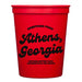 Red cup with black text 'Greetings from Athens, Georgia. Nothing better than Saturdays in the south.'