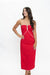 A woman modeling a bright red strapless maxi dress with white contrast piping and a white tie detail at the bust, set against a plain white studio background.