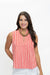 A woman modeling a sleeveless top with vertical red and white stripes, paired with white pants and a chunky gold necklace, against a plain white background.