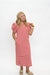 A woman modeling a red and white horizontally striped midi dress with puff sleeves, standing against a plain white studio background.