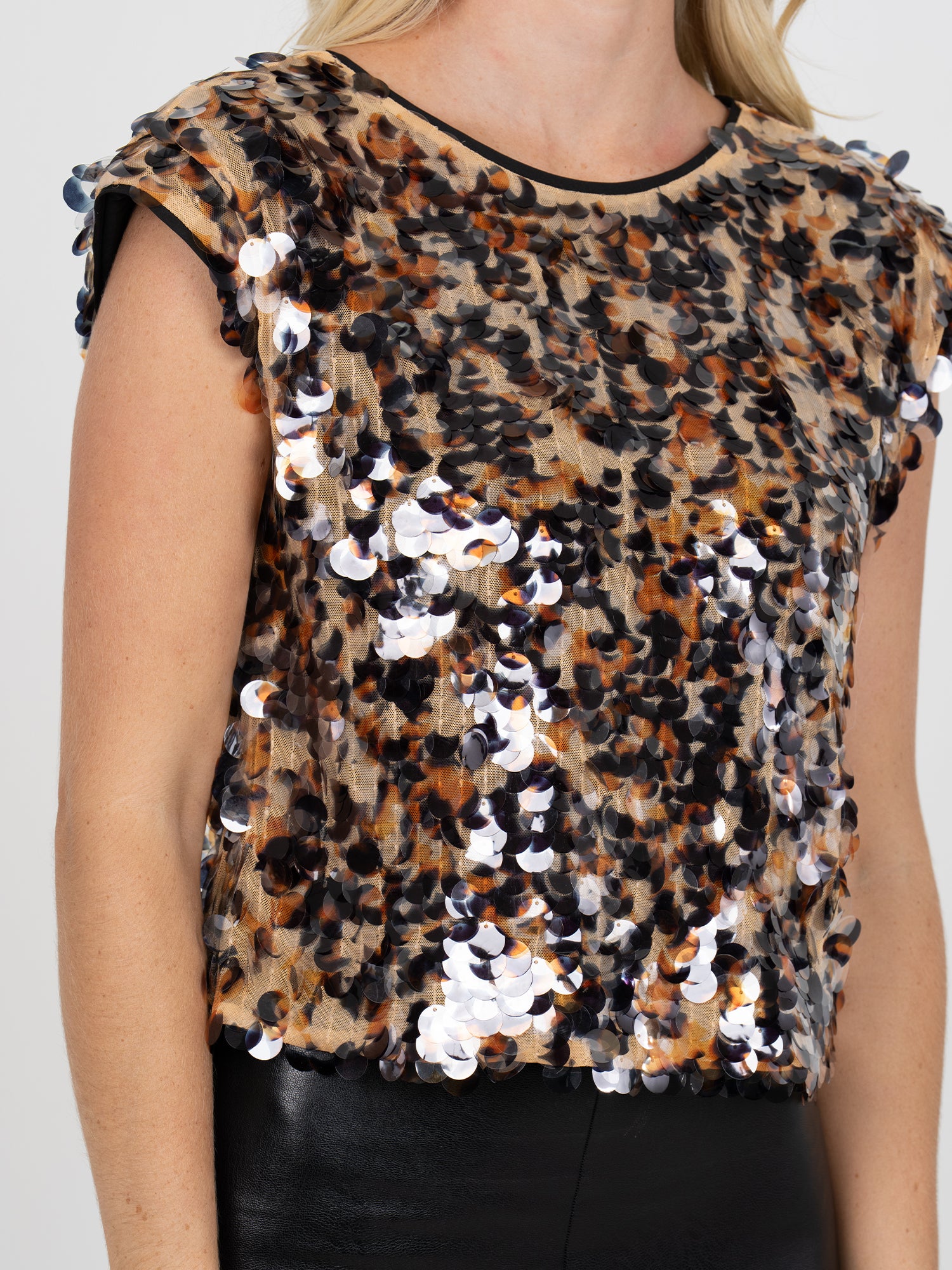 Leopard print top with sequins on a plain background