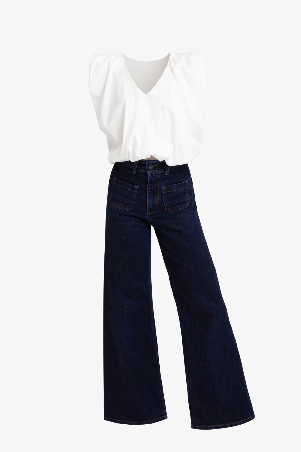 Navy blue wide-leg jeans worn with a white blouse on a white background