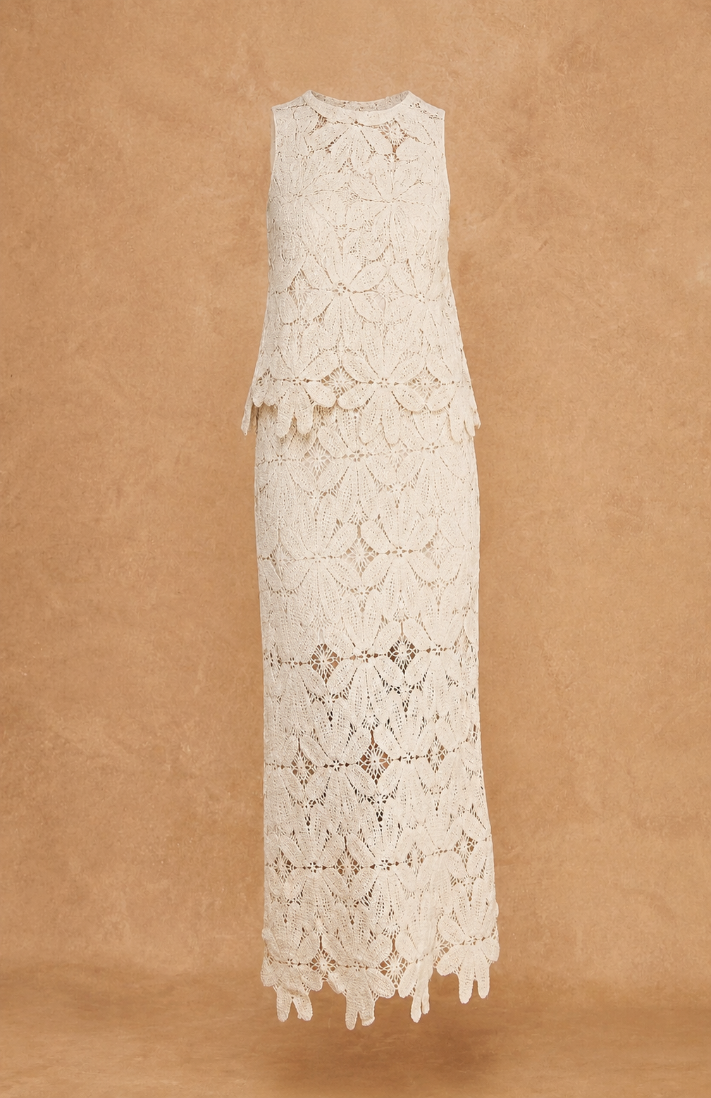 White lace set with skirt and sleeveless top on a brown background