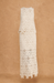 White lace set with skirt and sleeveless top on a brown background