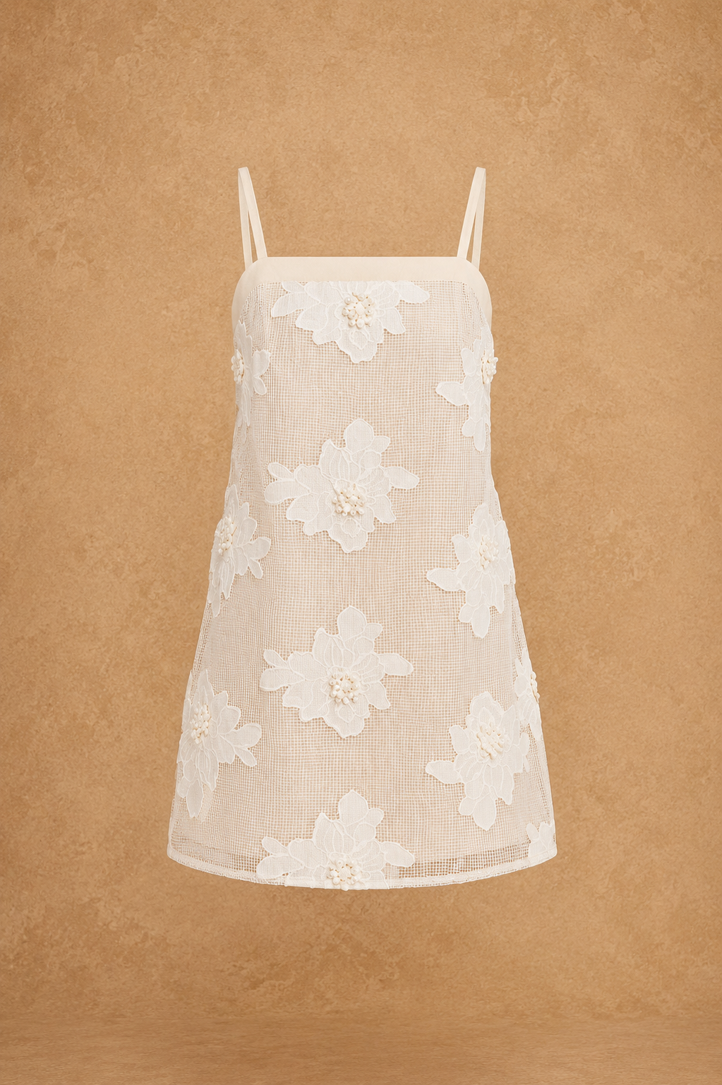 Beige lace dress with white floral patterns on a brown background