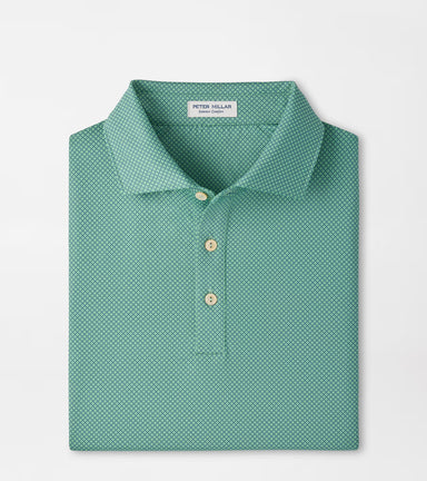 A folded Peter Millar men's polo shirt in a teal green color with a small white geometric pattern, featuring a collar and three buttons, set against a plain white background.