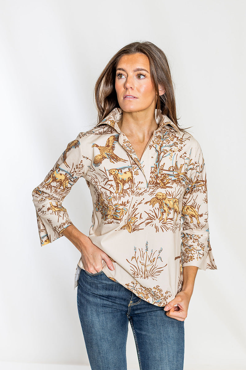 Woman wearing a patterned blouse with a plain background