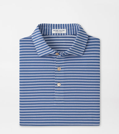 Folded blue and white striped polo shirt with 'Peter Millar' label on a light gray background