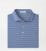 Folded blue and white striped polo shirt with 'Peter Millar' label on a light gray background