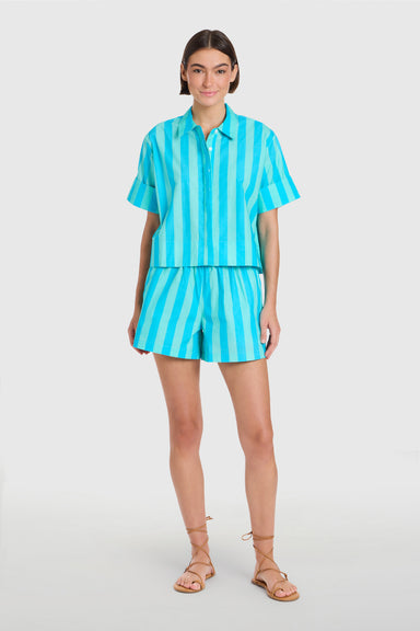 Woman wearing a turquoise striped outfit on a white background