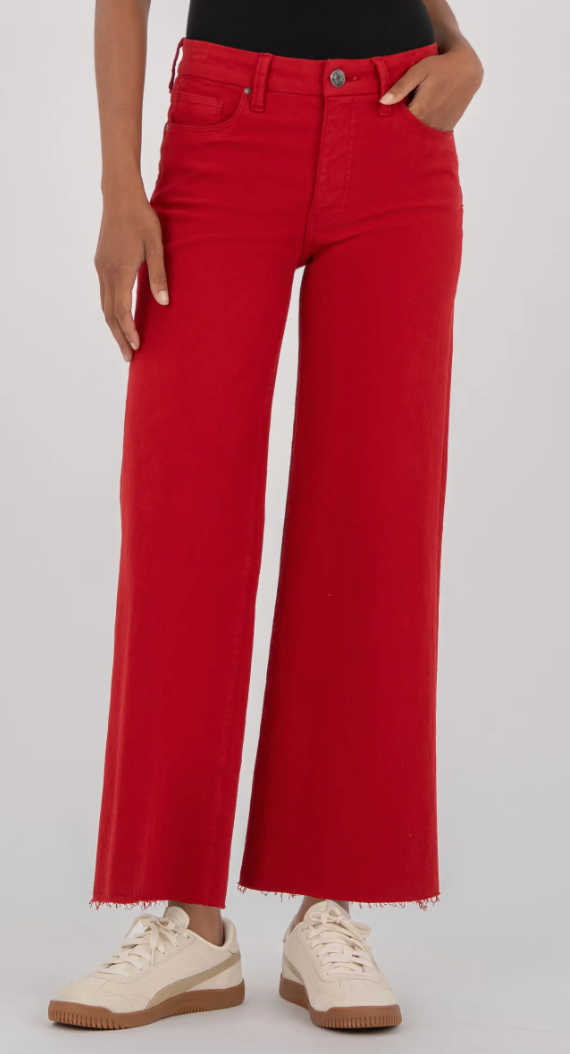 Red jeans worn by a person on a white background