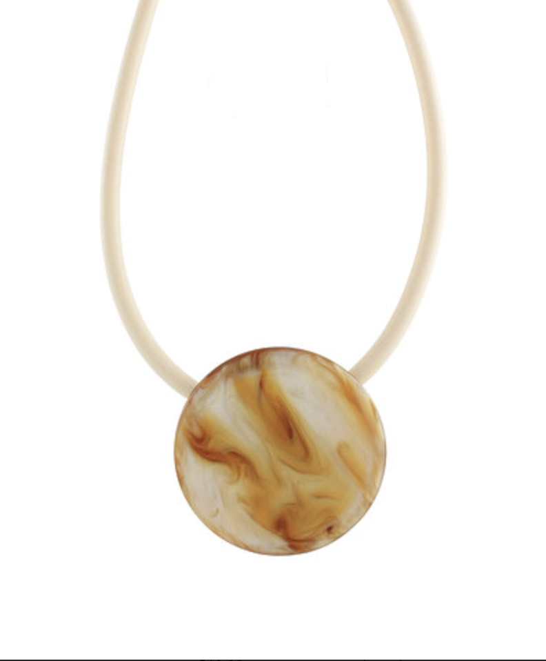 Necklace with a round, marbled pendant on a white background