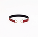 Black and red belt with gold hardware on a white background