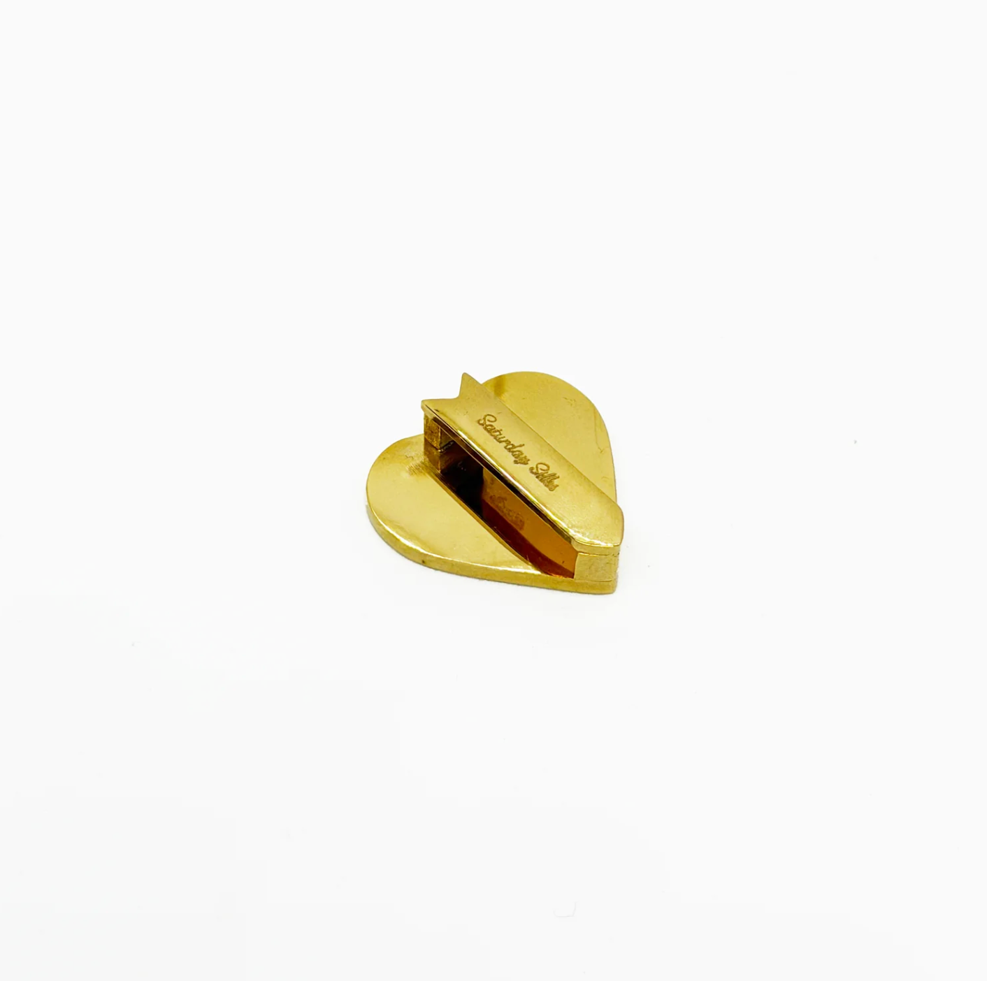 Gold heart-shaped object on a white background