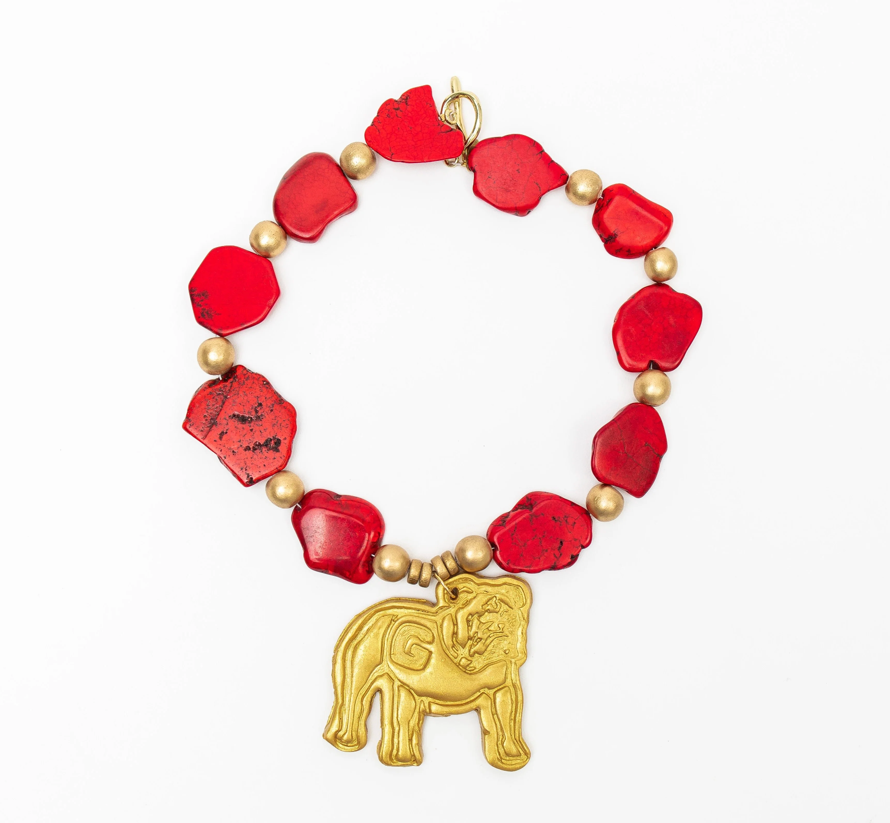 RED MARBLE AND GOLD BEADED NECKLACE WITH LARGE BULLDOG IN GOLD CLAY ON WHITE BACKGROUND
