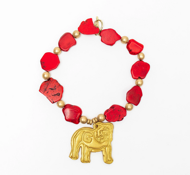 RED MARBLE AND GOLD BEADED NECKLACE WITH LARGE BULLDOG IN GOLD CLAY ON WHITE BACKGROUND
