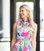 Woman wearing a colorful floral dress with a blurred background