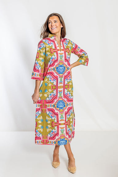 Woman wearing a colorful patterned dress on a white background