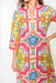 Colorful patterned dress worn by a person on a white background