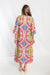 Woman wearing a colorful patterned dress on a white background