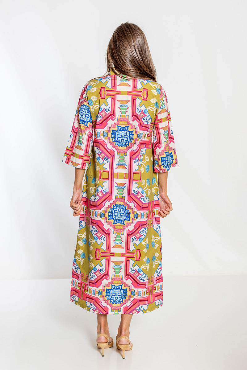 Woman wearing a colorful patterned dress on a white background