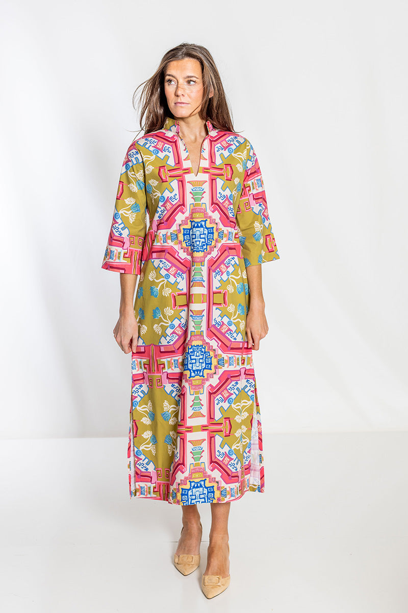 Woman wearing a colorful patterned dress on a white background