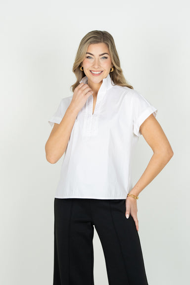 FRONT VIEW OF MODEL WEARING SOLID WHITE V NECK SHORT SLEEVE BLOUSE WITH POPPED COLLAR AND DETAIL ON V NECK