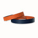 Two leather belts, one orange and one navy, on a white background