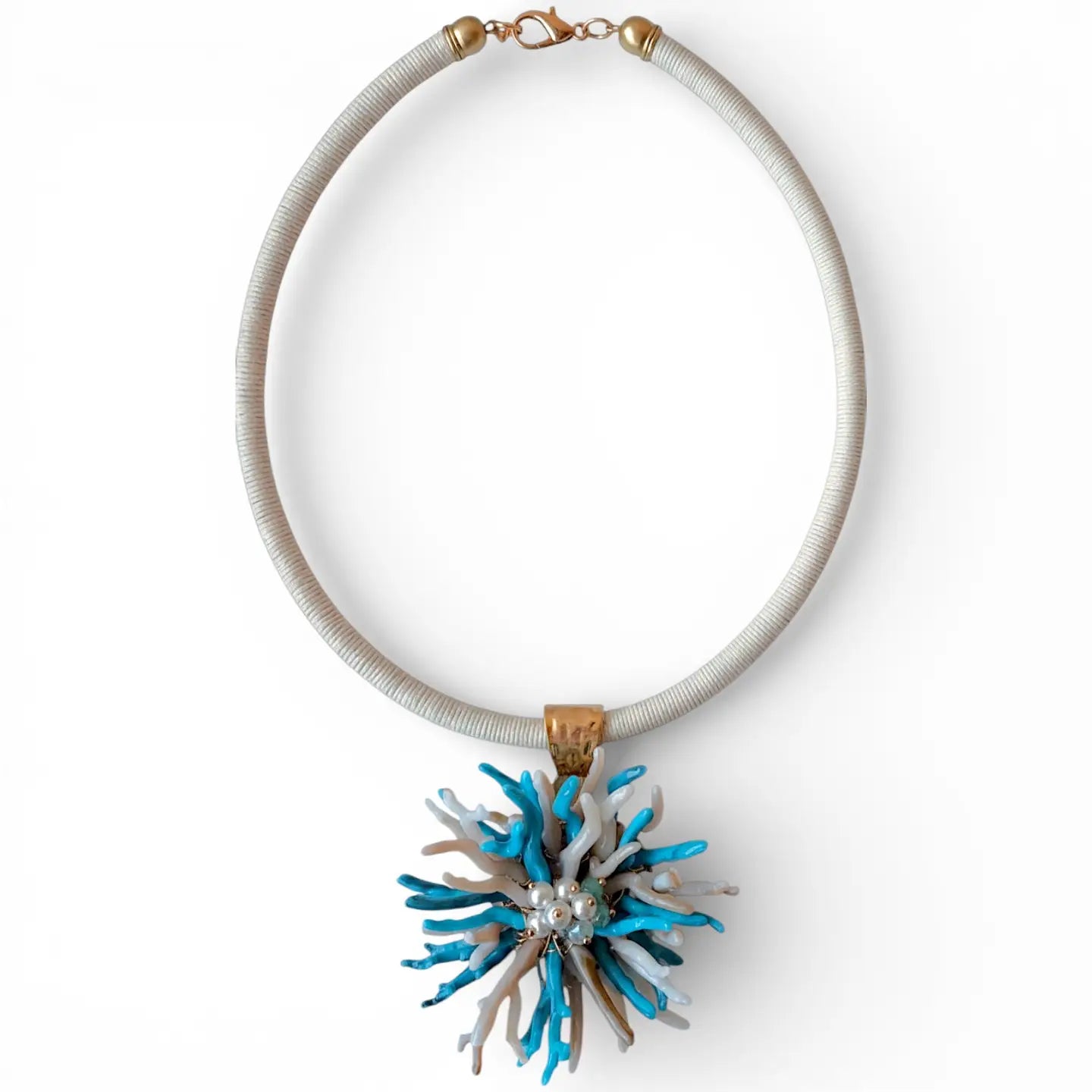 Necklace with a blue and white floral pendant on a white background