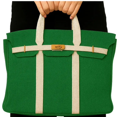 Green bag with beige straps held by a person against a white background