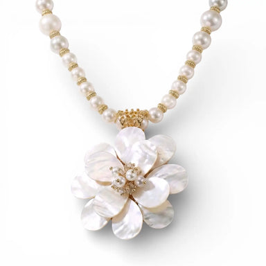Pearl necklace with a large floral pendant on a white background