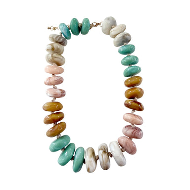 pink, tan, mint, and cream chunky beaded necklace with gold clasp on white background