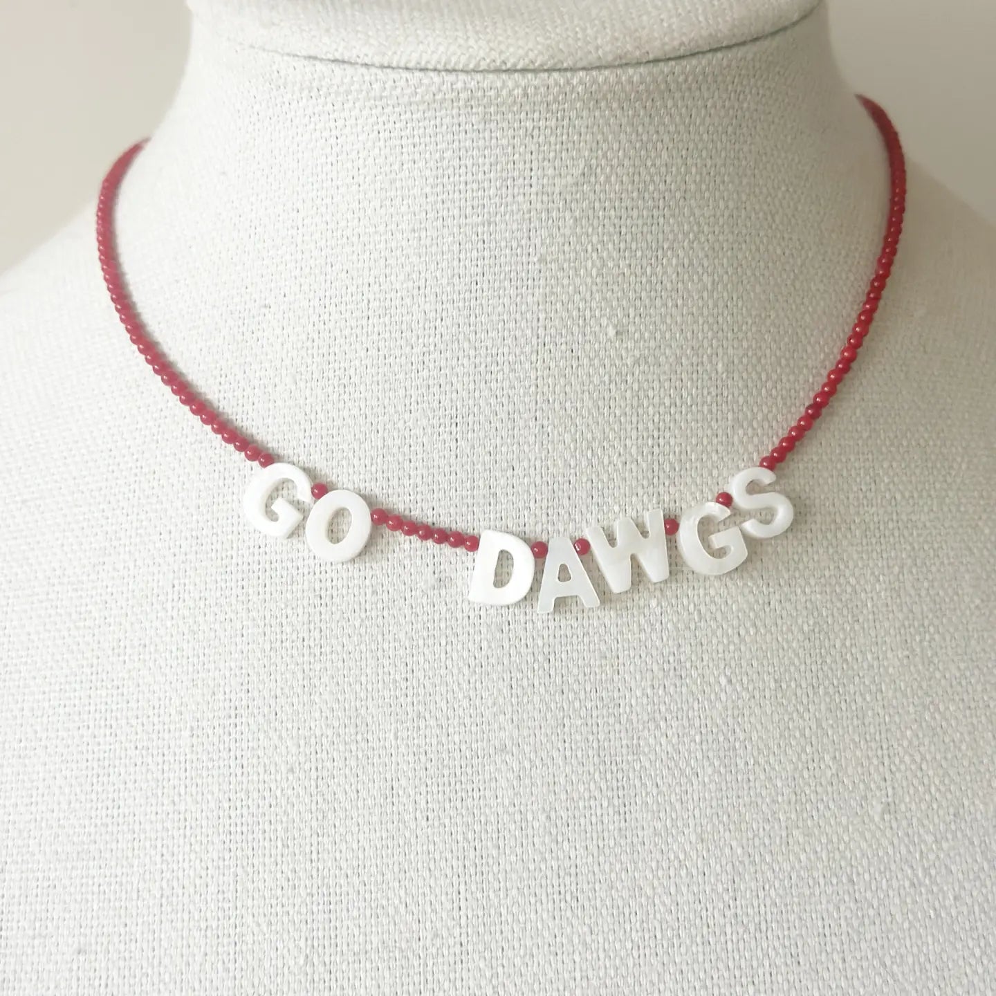 Necklace with 'GO DAWGS' on a mannequin bust