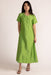 Woman wearing a green dress against a white background