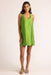 Woman wearing a green dress against a white background