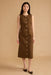 A woman modeling a sleeveless brown midi dress with a button-down front and side pockets, standing against a solid beige studio backdrop.