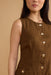Brown sleeveless top with button details on a beige background