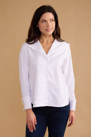 Woman wearing a white blouse against a beige background